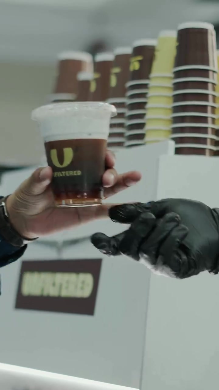 A coffee handed over at a forum stand