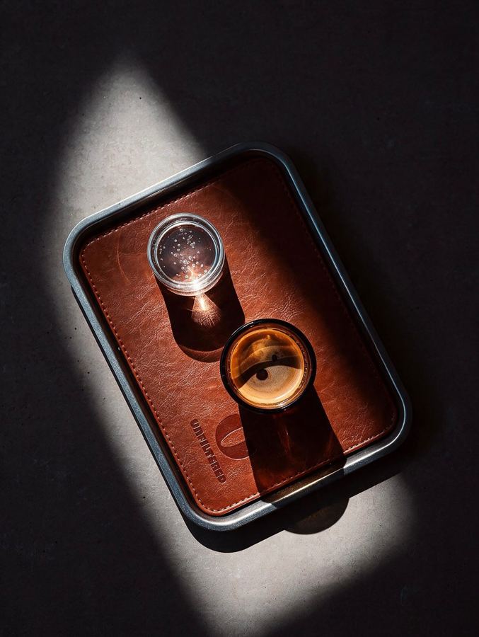An espresso on the leather U tray, from above