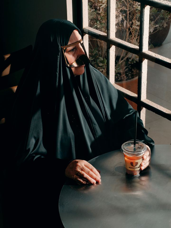 A guest by the window with an iced drink